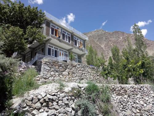 a house on top of a stone wall at Hunza Holiday Inn in Baltit