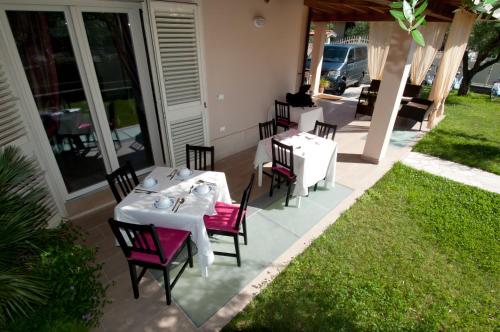 a restaurant with tables and chairs on a patio at B&B Alle Tre Rose in Montignoso