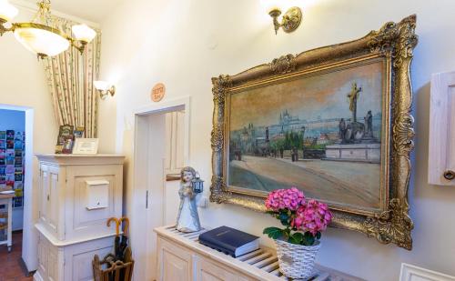 a painting hanging on a wall in a room at Loreta Hotel in Prague