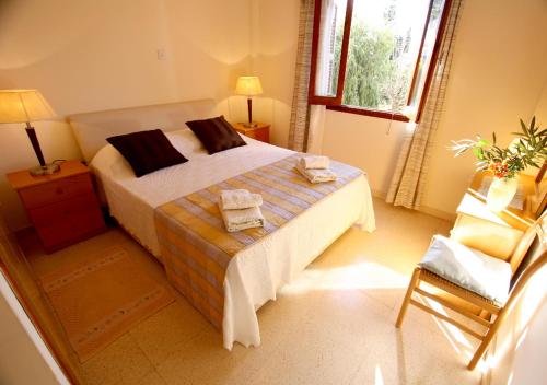 a bedroom with a bed with two towels on it at Maria Villa in Pissouri