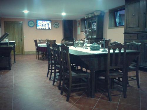 a dining room with a table with chairs and a television at Quinta Da Penela in Vieira do Minho