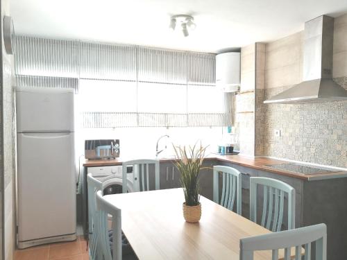 eine Küche mit einem Tisch und Stühlen sowie einem Kühlschrank in der Unterkunft Casa Isabel in San José