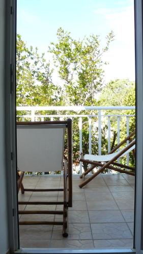 a bench sitting on top of a balcony at Eco Apartments Kate in Suđurađ