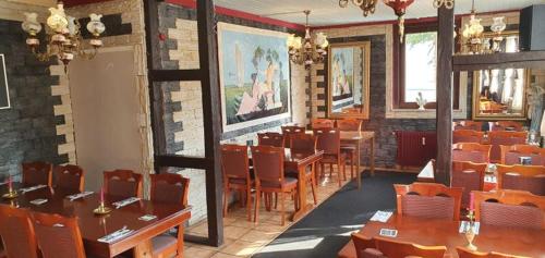 a dining room with tables and chairs in a restaurant at Dionysos Traube in Rottweil