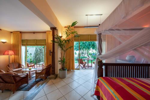 a bedroom with a bed and a living room at The Max Wadiya in Ambalangoda