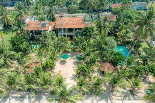 an aerial view of a resort with palm trees at The Max Wadiya in Ambalangoda
