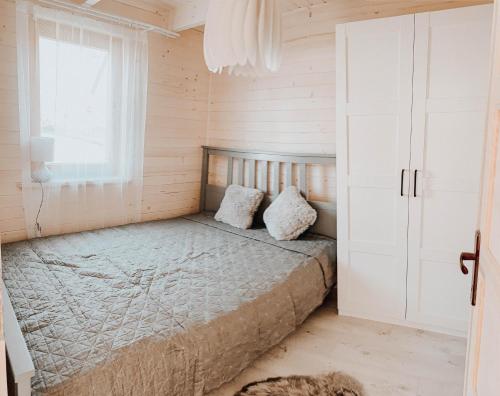 a bedroom with a bed and a window at Eko Domek w górach in Korbielów