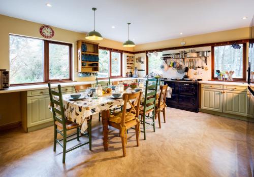 a kitchen with a dining room table and chairs at Glentruim Homestay B&B in Newtonmore