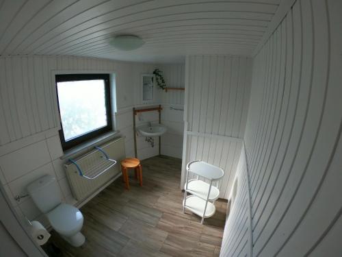 a small bathroom with a sink and a toilet at Ferienwohnung zur Schmiede in Altendorf