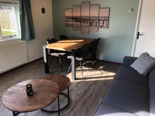 a living room with a table and a couch at Anna in Hollum
