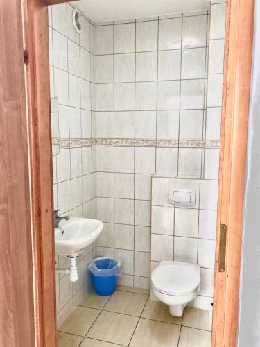 a small bathroom with a toilet and a sink at Azymut in Władysławowo