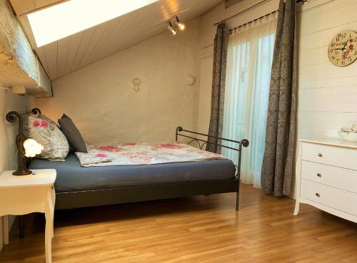 a small bedroom with a bed in a attic at Joline private guest apartment downtown Nidau in Nidau