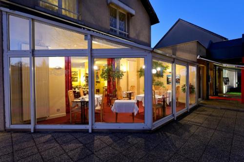 an extension of a house with sliding glass doors at Logis Hôtel Restaurant Du Lion D'argent Et Des Tanneries in La Châtre
