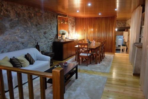 a living room with a white couch and a table at My Portugal for All - Lousada Villa in Lousada