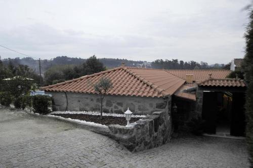 a house with a tile roof and a courtyard at My Portugal for All - Lousada Villa in Lousada