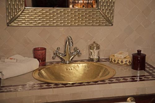 a gold sink on a counter in a bathroom at Riad Daria Suites & Spa in Marrakech
