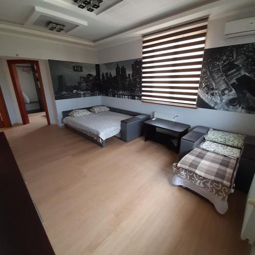 a bedroom with a bed and a couch and a window at Villa Costa in Sanzhiyka
