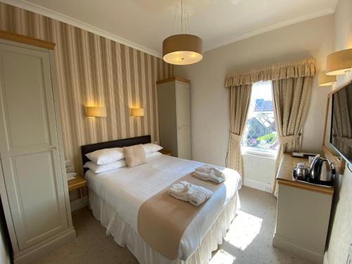 Ein Bett oder Betten in einem Zimmer der Unterkunft Bedford Hotel