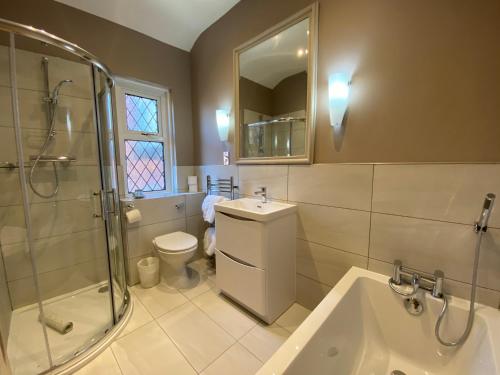 a bathroom with a toilet and a shower and a sink at Bedford Hotel in Lytham St Annes
