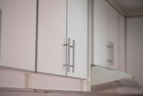 a row of white cabinets in a kitchen at RondPoint Pilar in Pilar