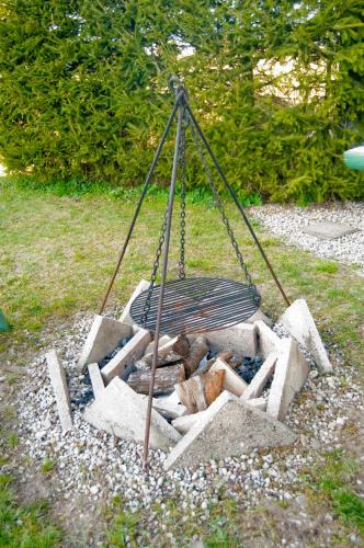 a swing with a fire in a pile of rocks at Świerkowy Zakątek in Orzysz