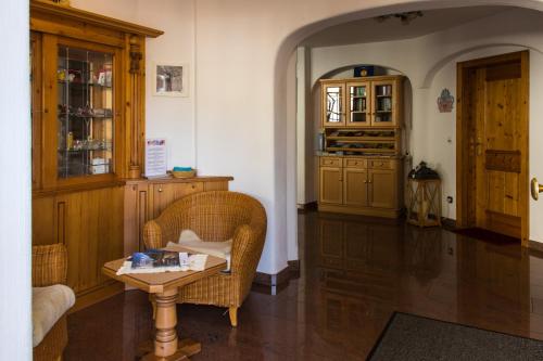 a living room with two chairs and a table at Hotel Rosenhof in Ruhpolding