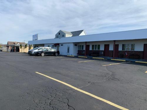 a car parked in a parking lot in front of a building at Budget Inn in Belle Vernon