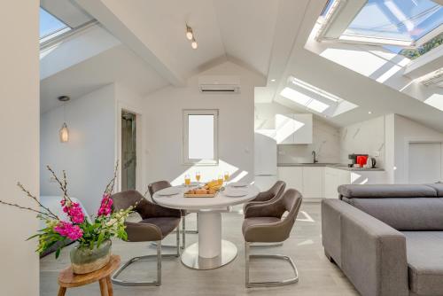 a living room with a table and chairs at CAPITAL Apartments and Rooms in Split