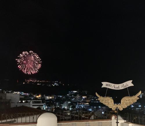 a firework display in the sky over a city at Hotel Santa Paula in Taxco de Alarcón