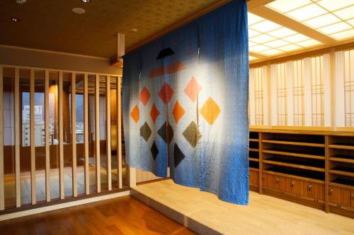 a room with a wall with a blue curtain at The Shiroyama Terrace Tsuyama Villa in Tuyama