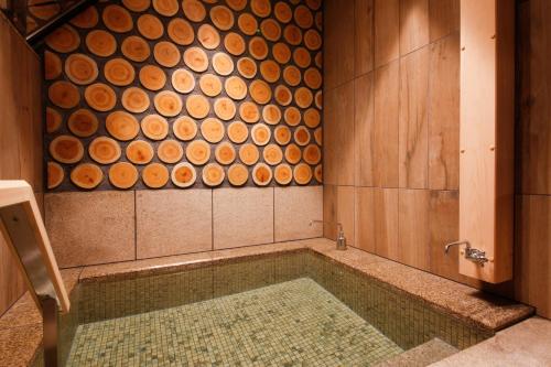 a bathroom with a tub with a painting on the wall at The Shiroyama Terrace Tsuyama Villa in Tuyama