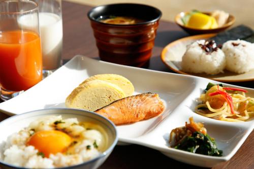 a table with a plate of food on a table at The Shiroyama Terrace Tsuyama Villa in Tuyama