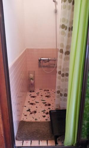 een badkamer met een douche en een tegelvloer bij Matsumoto BackPackers in Matsumoto