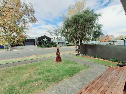 a statue of a teddy bear sitting on the grass at Tongariro River Retreat in Turangi