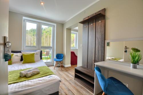 Postel nebo postele na pokoji v ubytování SPA & RESORT BUKOWIEC