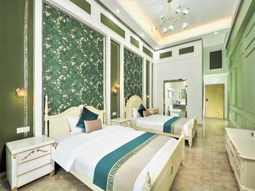 a bedroom with two beds and a large window at April Fair Duplex Apartment Guangzhou South Railway Station Ao Yuan Yue Shi Dai Branch in Guangzhou