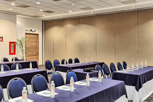 a conference room with tables and chairs with bottles of water at Holiday Inn Express Villahermosa by IHG in Villahermosa