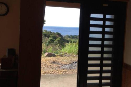 a view of the ocean from a window at 屋久島シエスタYakushima Entire house with a wonderful view in Yakushima