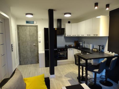 a kitchen with a table and a counter top at No71 The Luxury Apartment in Głogów