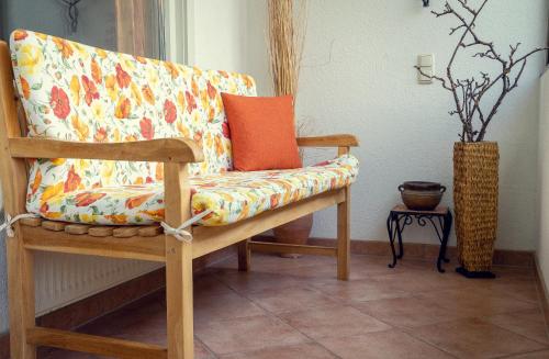 a couch with an orange pillow on it in a room at Haus Stangl in Bad Aussee