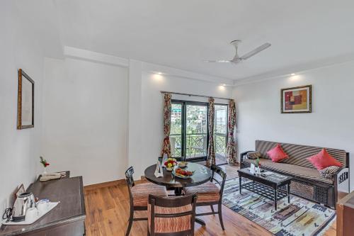 a living room with a couch and a table at Club Mahindra Snow Peaks Manali in Manāli