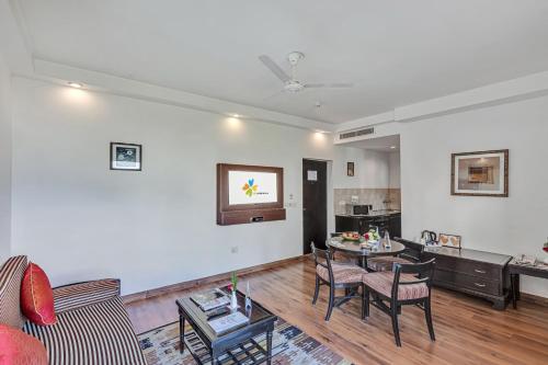 a living room with a table and chairs at Club Mahindra Snow Peaks Manali in Manāli