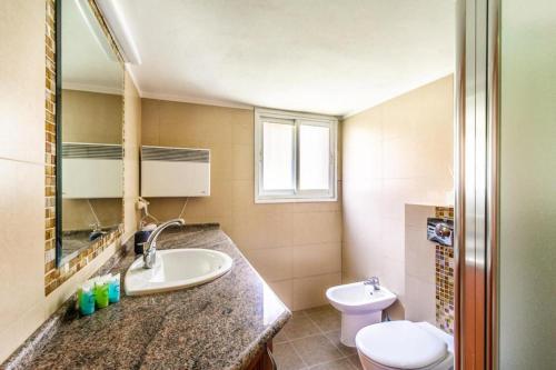 a bathroom with a sink and a toilet at Molho 2BR for 6 guests in Jerusalem