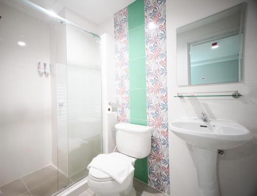 a bathroom with a toilet and a sink at The Willing Hotel and Residence in Lak Si