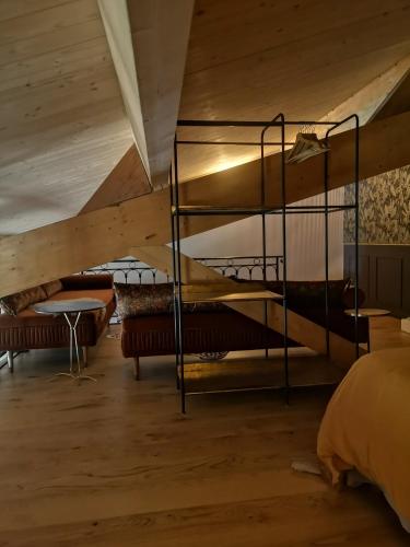 a bedroom with bunk beds and a wooden ceiling at La Gourgasse Vieille in Béziers