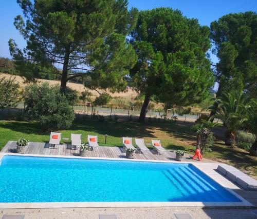 a swimming pool with lounge chairs and a swimming pool at La Gourgasse Vieille in Béziers