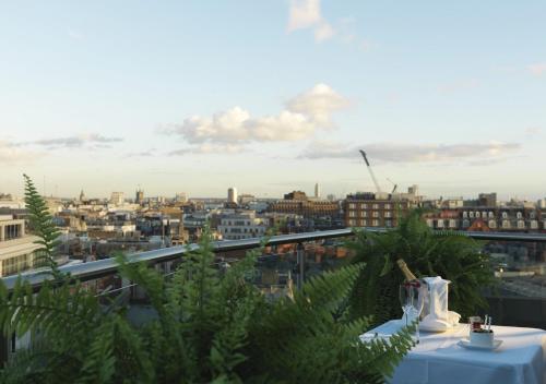 a table with a view of a city at Radisson Blu Hotel, London Bond Street in London