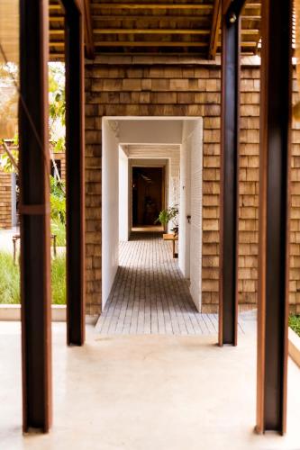 a hallway of a house with a brick wall at Roukh Kiri Khaoyai, The Centara Collection in Pak Chong