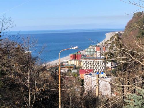 a town on a hill next to the ocean at Chalet Kvariati in Kvariat'i