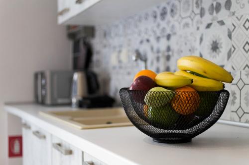 a bowl of fruit on a counter in a kitchen at Classic Corfiot Town House in Corfu